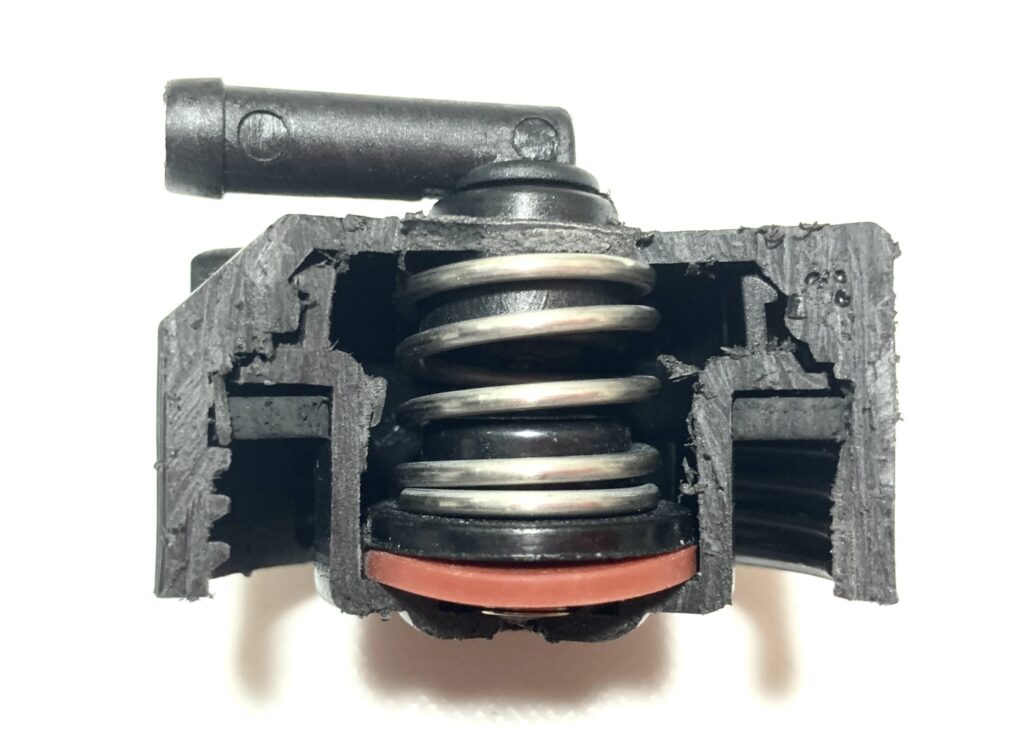 Cross-sectional view of the internal construction of a cut-open Ferrari radiator cap, part number 145030